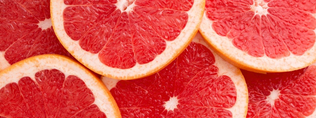 A close-up image of grapefruit slices
