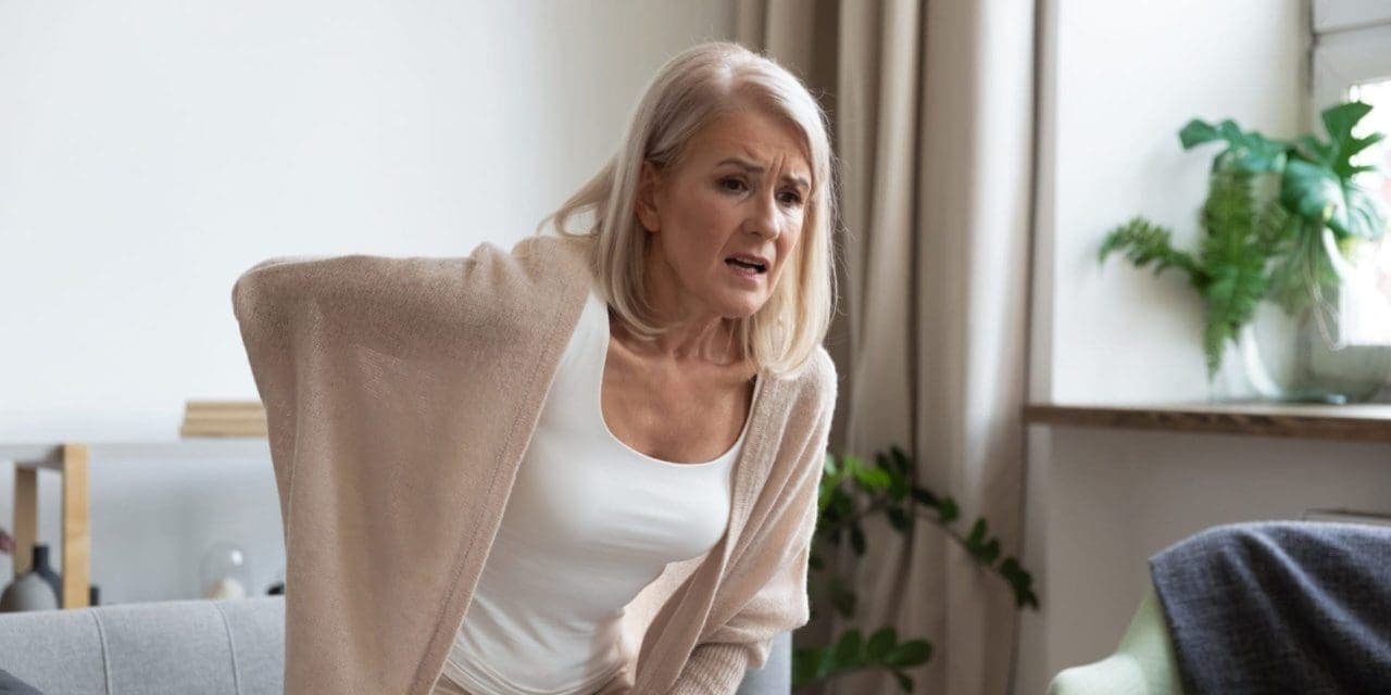 older woman holding on to a painful lower back