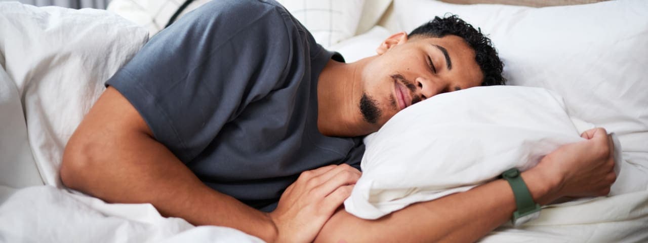 A man sleeping soundly in his bed